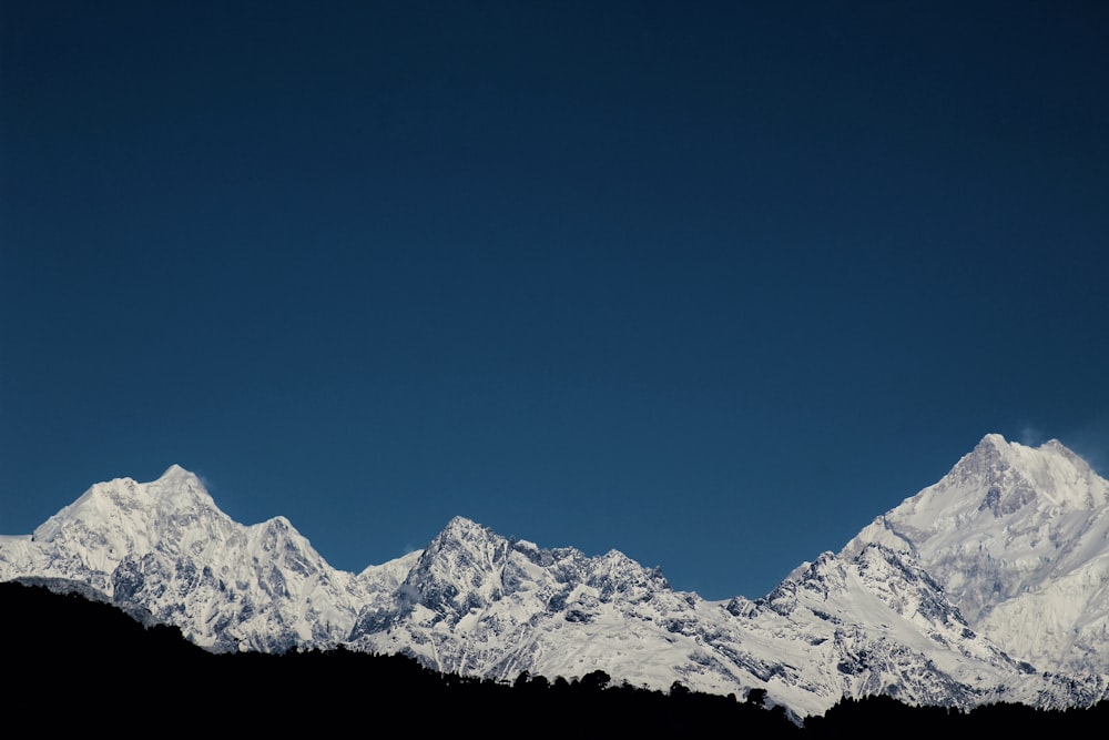 snow covered mountain under blue sky during daytime