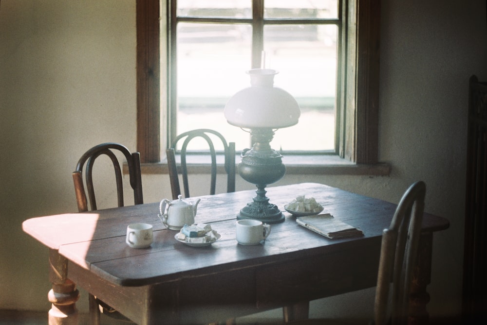 white ceramic teacup on brown wooden table