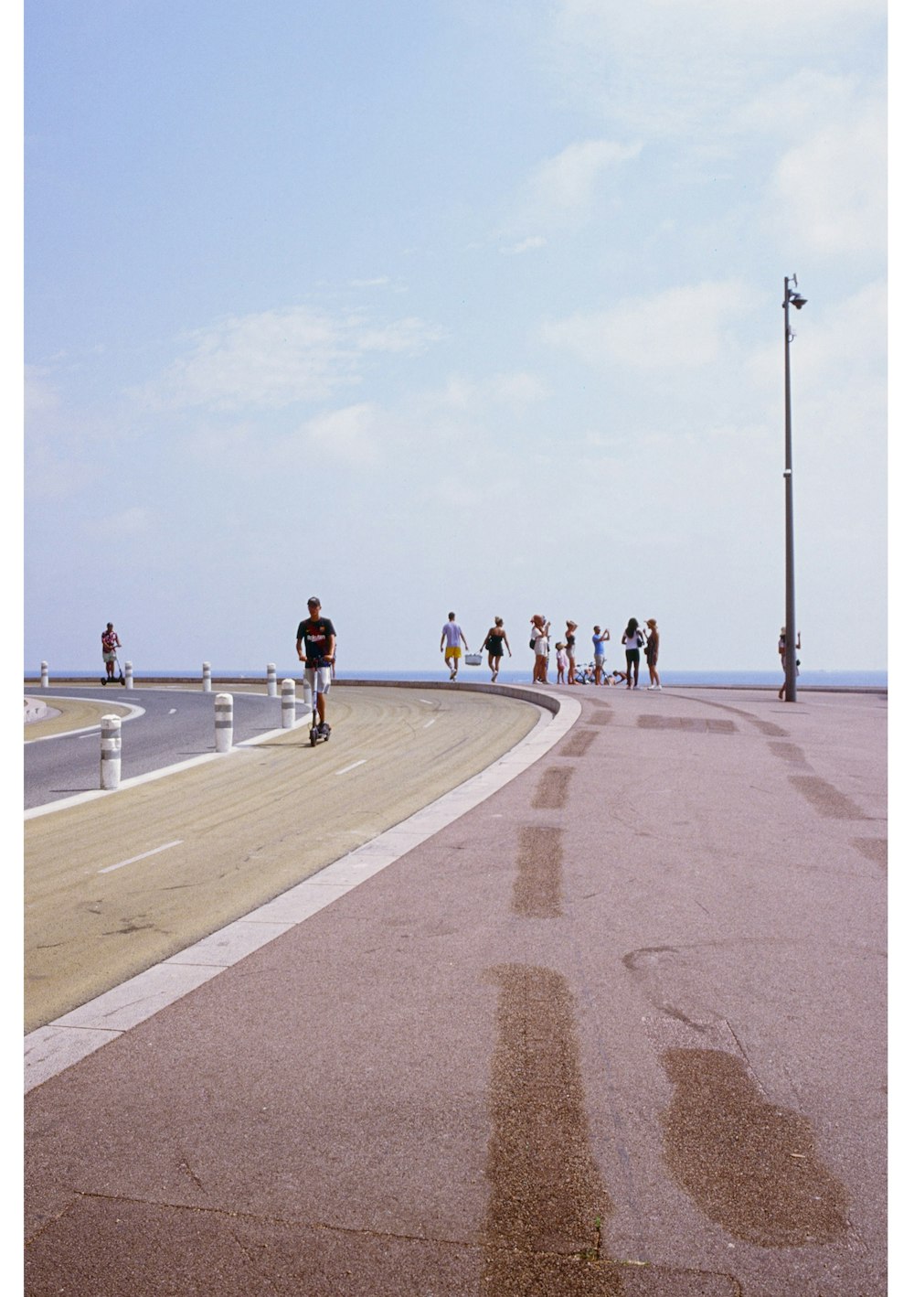 people walking on gray concrete road during daytime