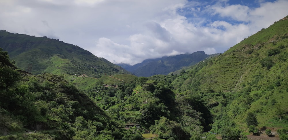 green mountains under white clouds during daytime