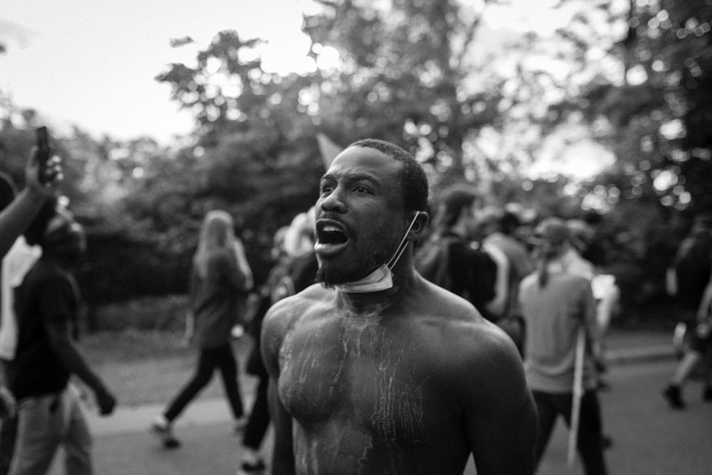 grayscale photo of topless man