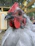 Close-up of a Hatch Grey gamefowl with intense eyes and sleek feathers, poised for battle.