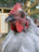 Close-up of a Hatch Grey gamefowl with intense eyes and sleek feathers, poised for battle.