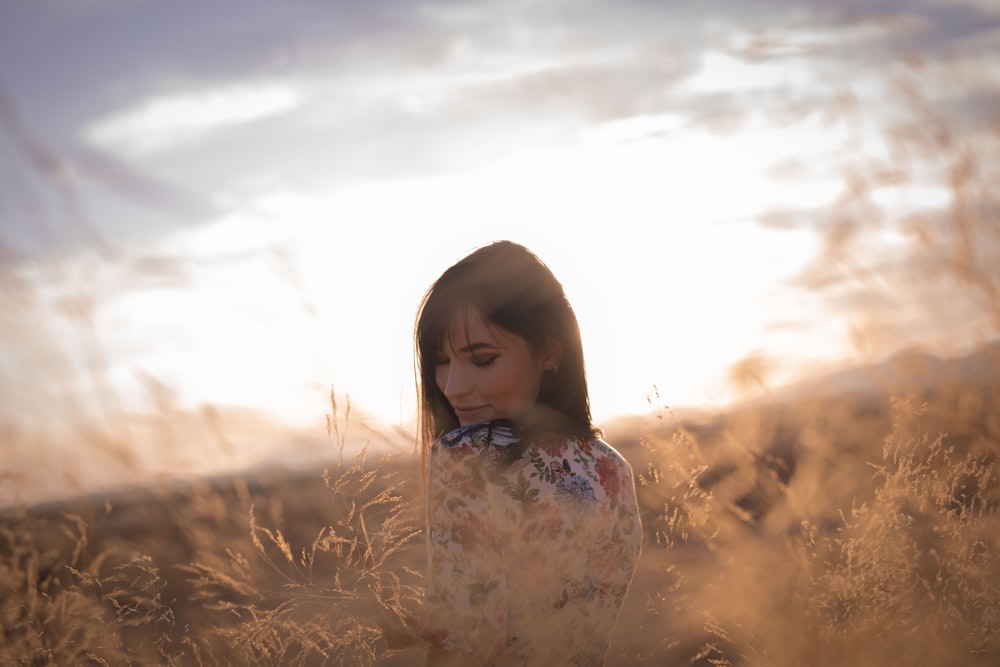 girl in white floral dress on brown grass field during daytime