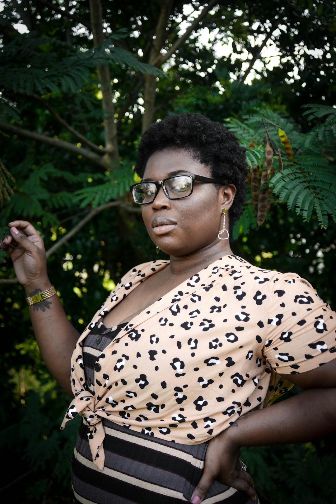 woman in white and black leopard print shirt wearing black framed eyeglasses