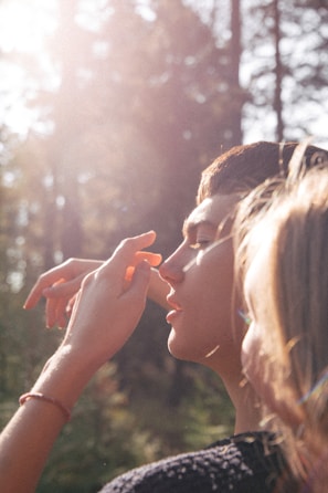 Soft, glowing skin on a person gently touching their arm outdoors.