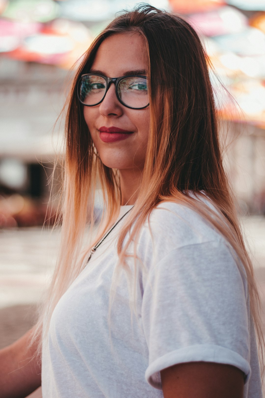 woman in white shirt wearing black framed eyeglasses