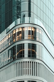 A sleek, modern residential building in Toronto with clean lines and large windows reflecting the city skyline.