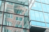 Glass work on a building facade reflecting the surrounding environment.