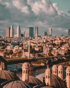 city skyline under white cloudy sky during daytime