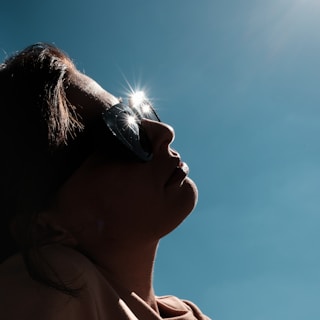 woman in white tank top wearing black sunglasses during daytime