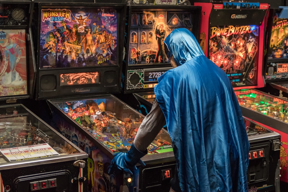 man in blue robe standing in front of food display counter