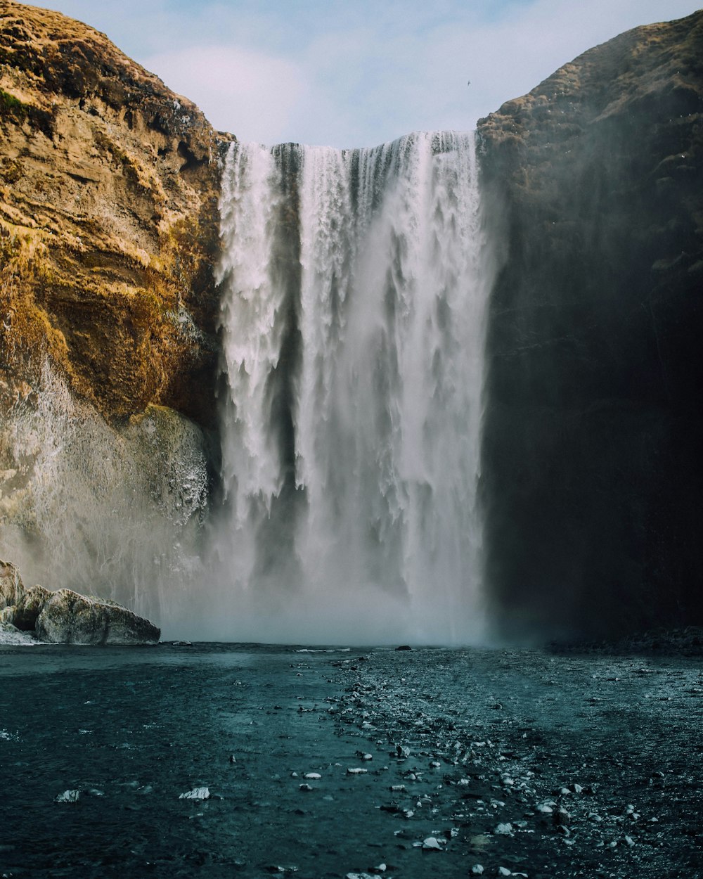 waterfalls on rocky mountain during daytime