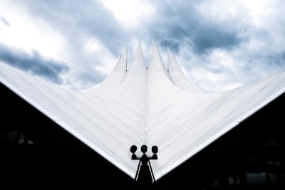 white concrete building under blue sky during daytime archi-texture zoom background