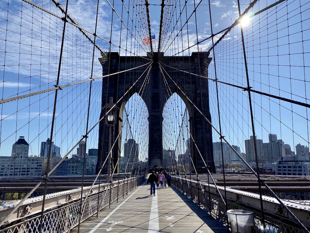 people walking on bridge during daytime