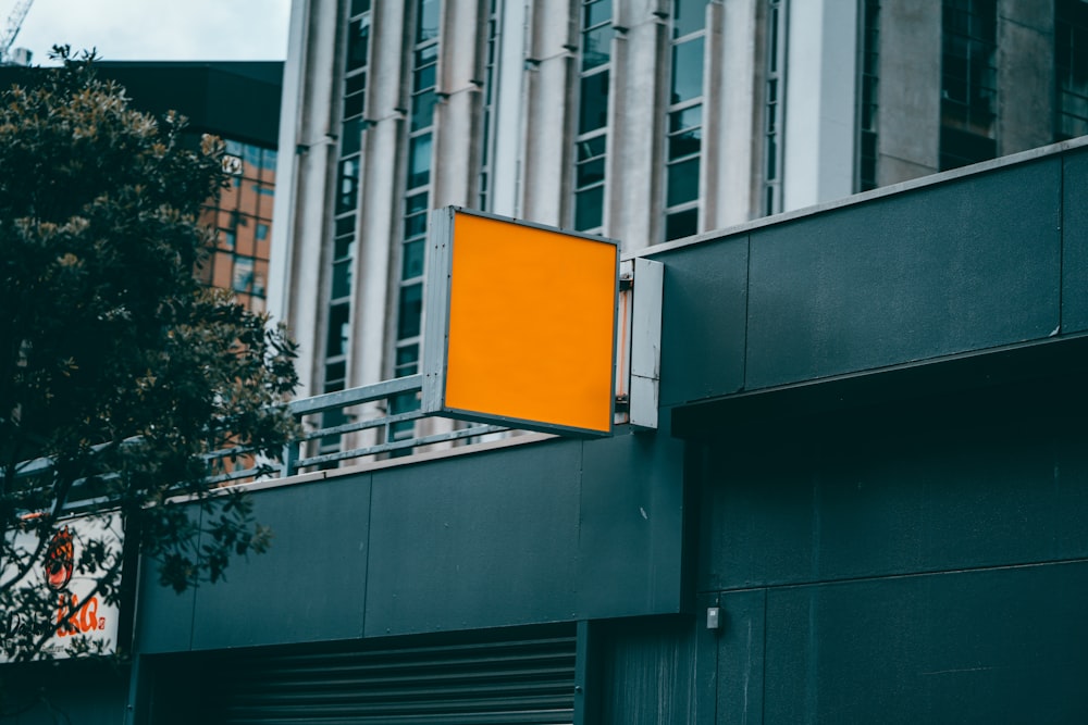 white and yellow basketball hoop on gray building