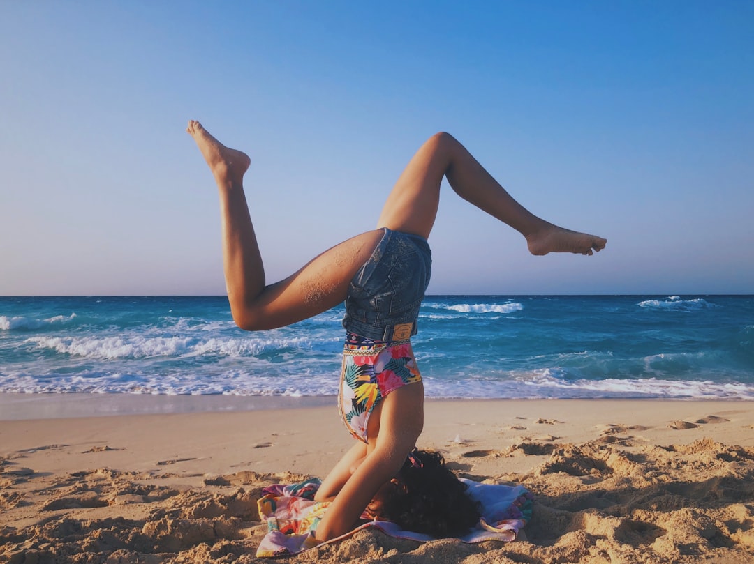 woman in blue and white floral bikini standing on beach during daytime