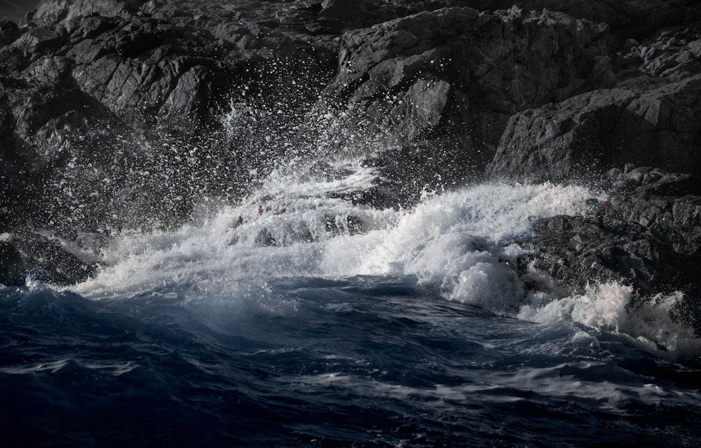 water waves hitting rocky shore during daytime