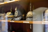 Historic military artifacts and medals displayed on a wooden table with informational plaques.