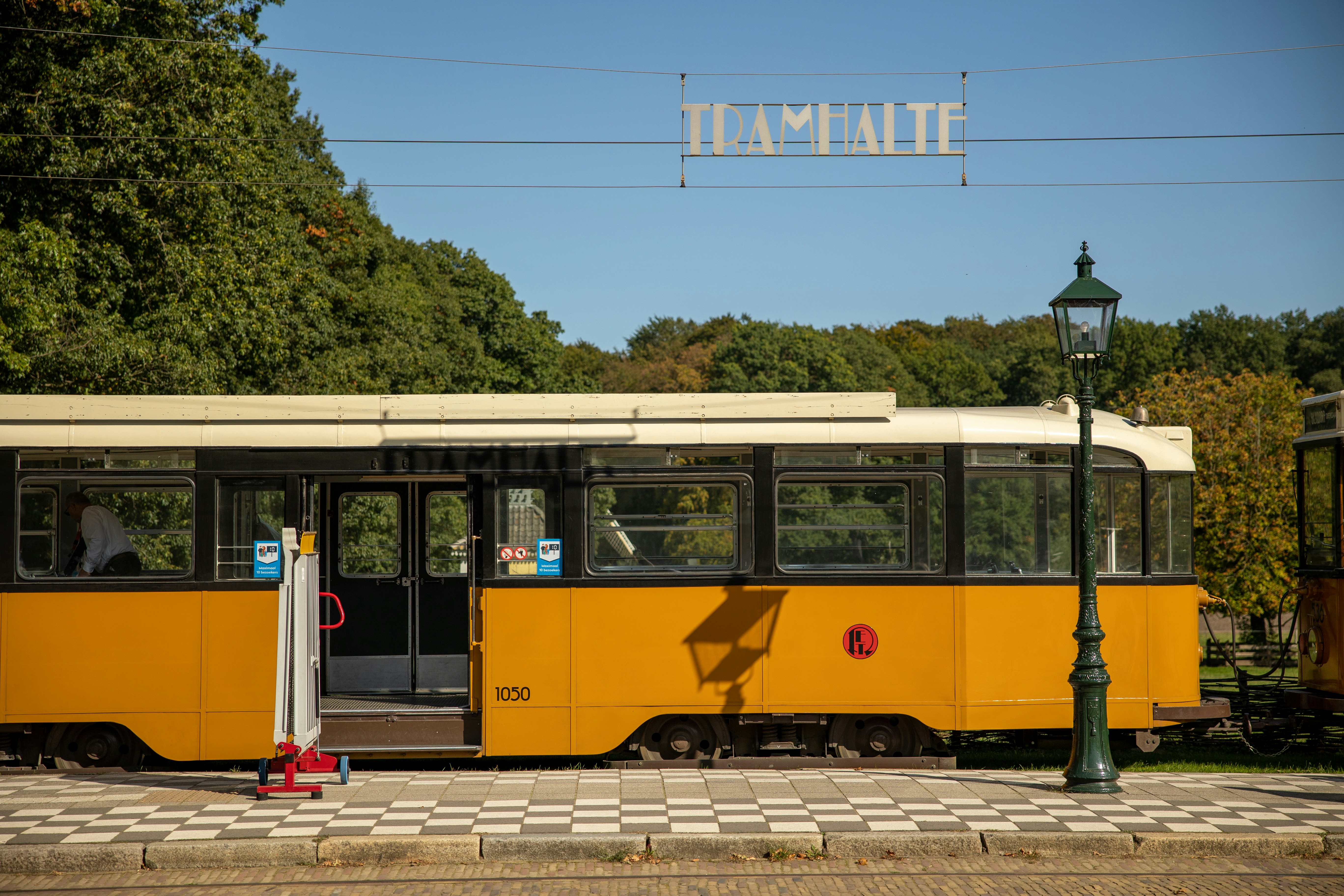 yellow and white tram on road during daytime