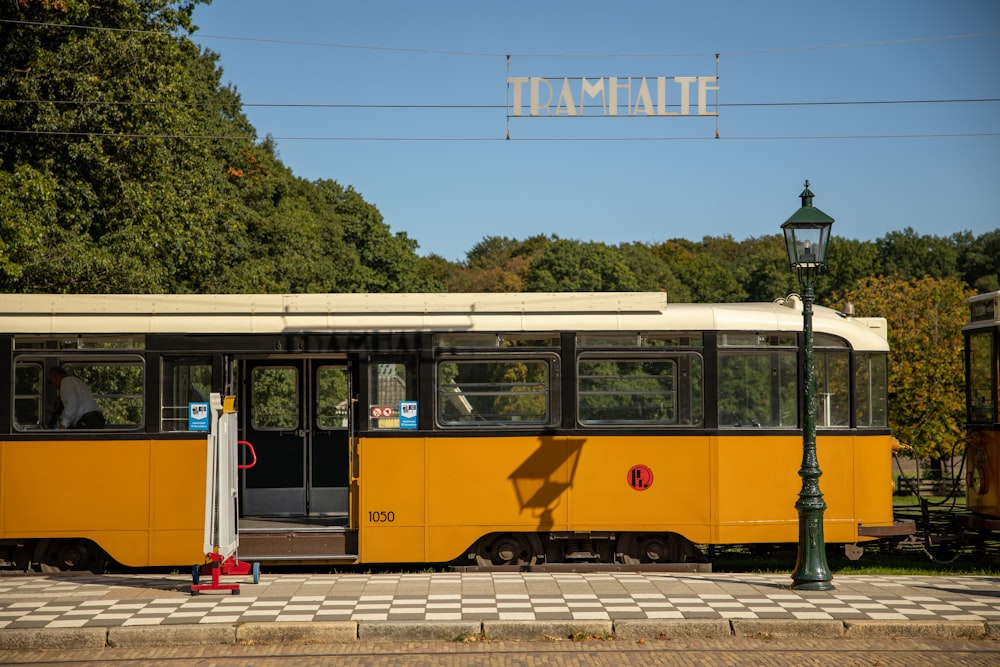 gelb-weiße Straßenbahn tagsüber auf der Straße