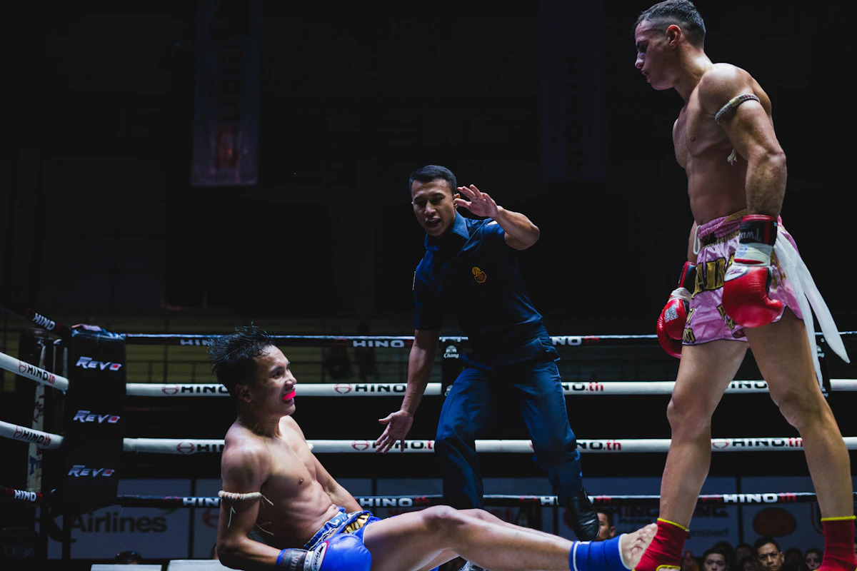 Two fighters sparring in a ring at night