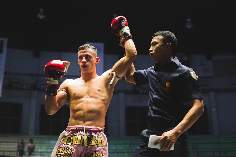 man in black and white jersey shirt holding red and black boxing gloves