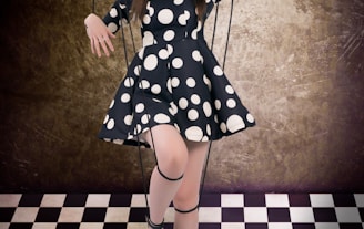 girl in black and white polka dot dress