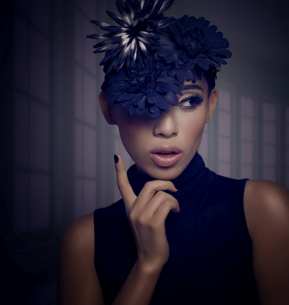 woman in black tank top with blue and white floral headdress