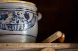 Close-up of decorative terracotta pottery on a shelf.