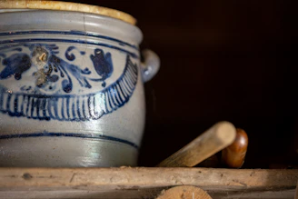 Close-up photo of a beautifully aged antique pottery vase with intricate patterns.
