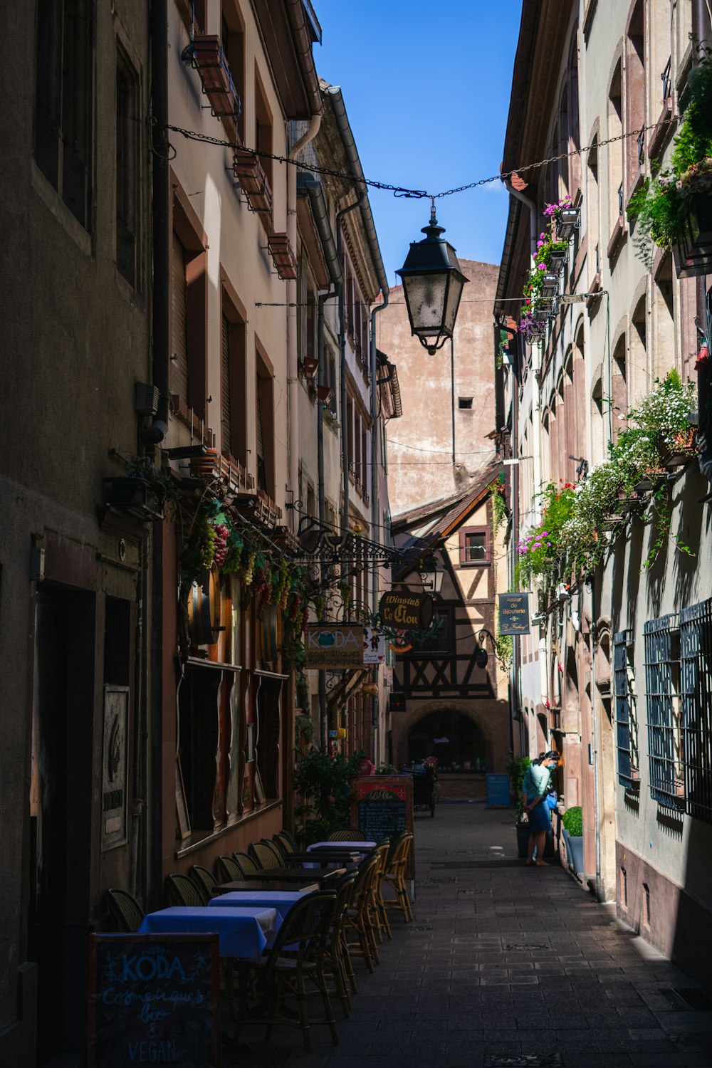 people walking on street between buildings during daytime