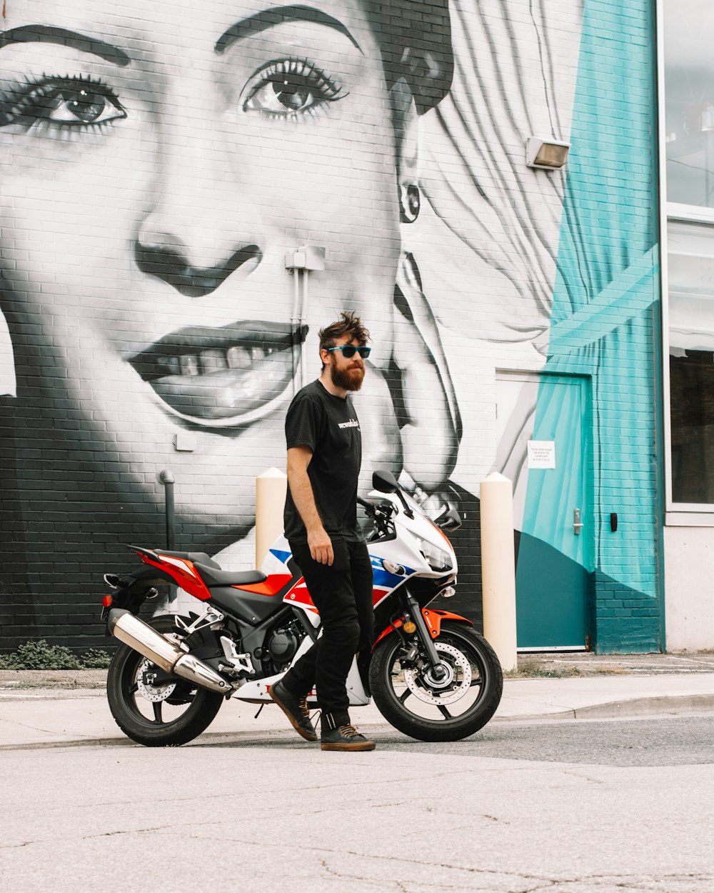 woman in black tank top riding red motorcycle