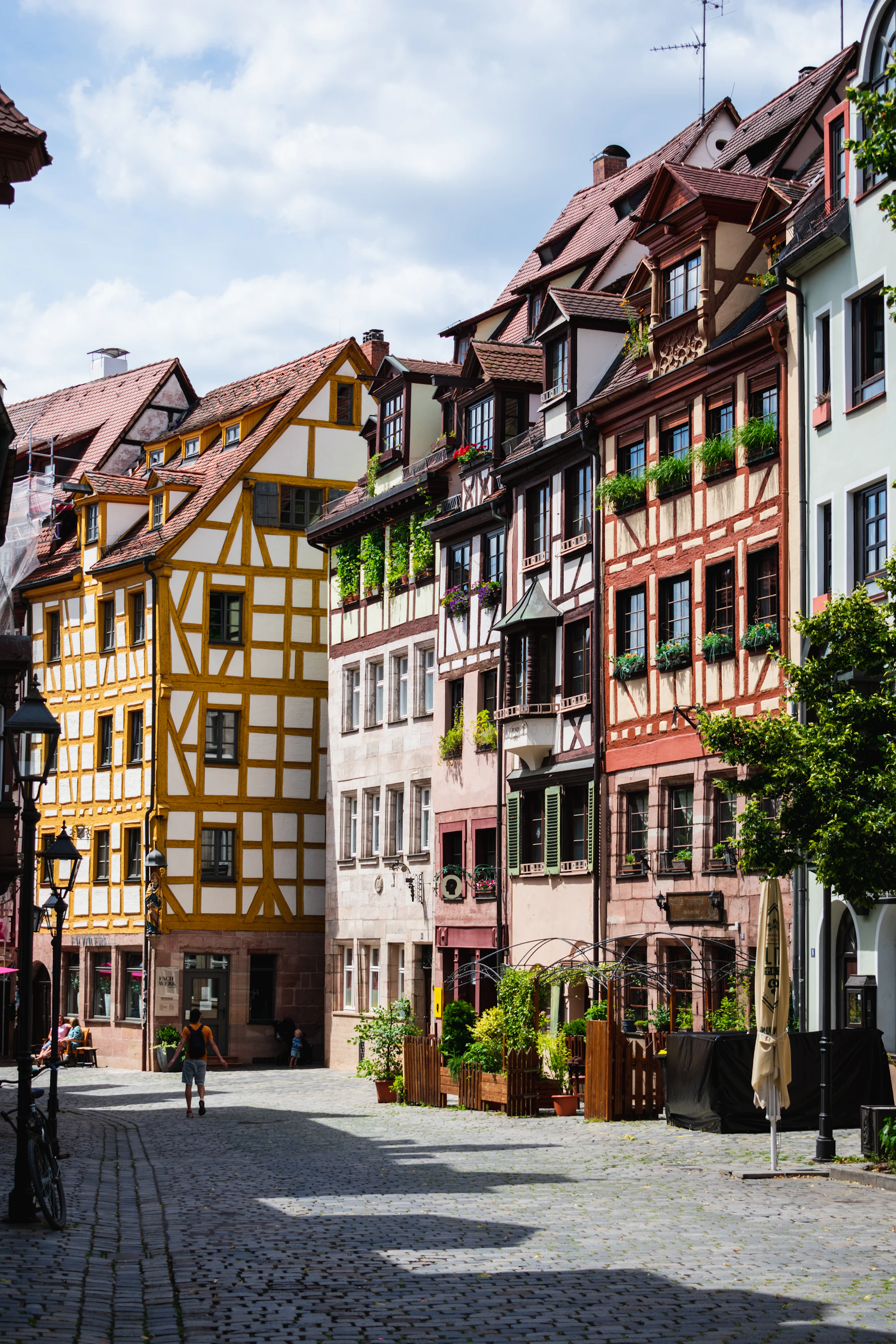 A yellow and white building faces a city street.