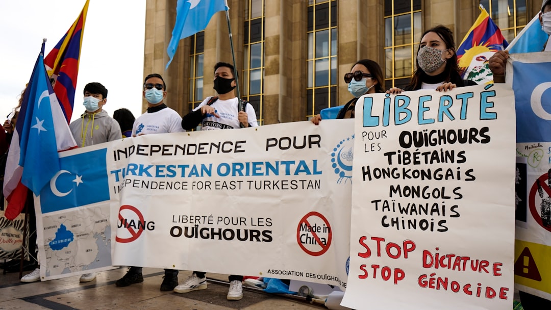 2 women standing in front of white and blue banner