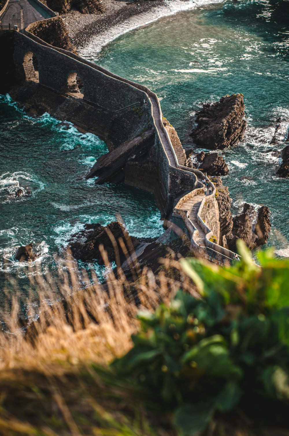 brown rock formation on body of water during daytime