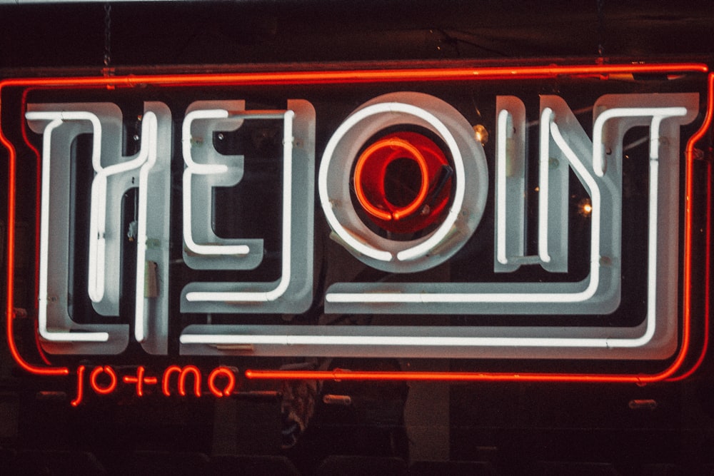 a close up of a neon sign on a building