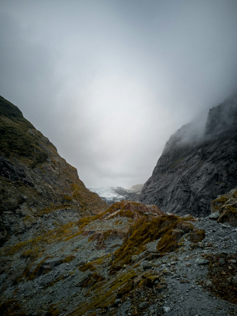 gray rocky mountain under white clouds during daytime