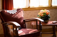 Cozy corner with a vintage armchair and golden accents overlooking the historic Blois street.