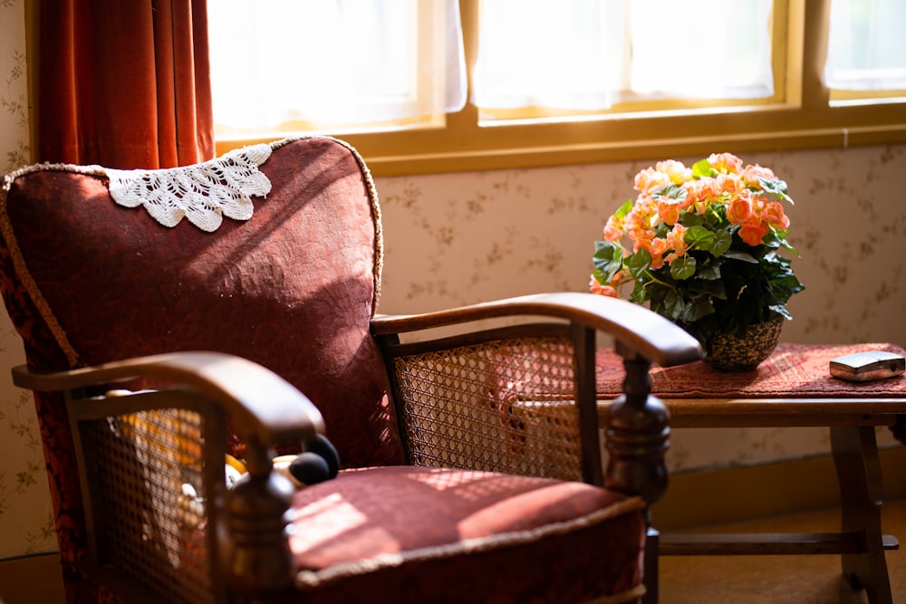 brown wooden armchair beside white and brown floral throw pillow