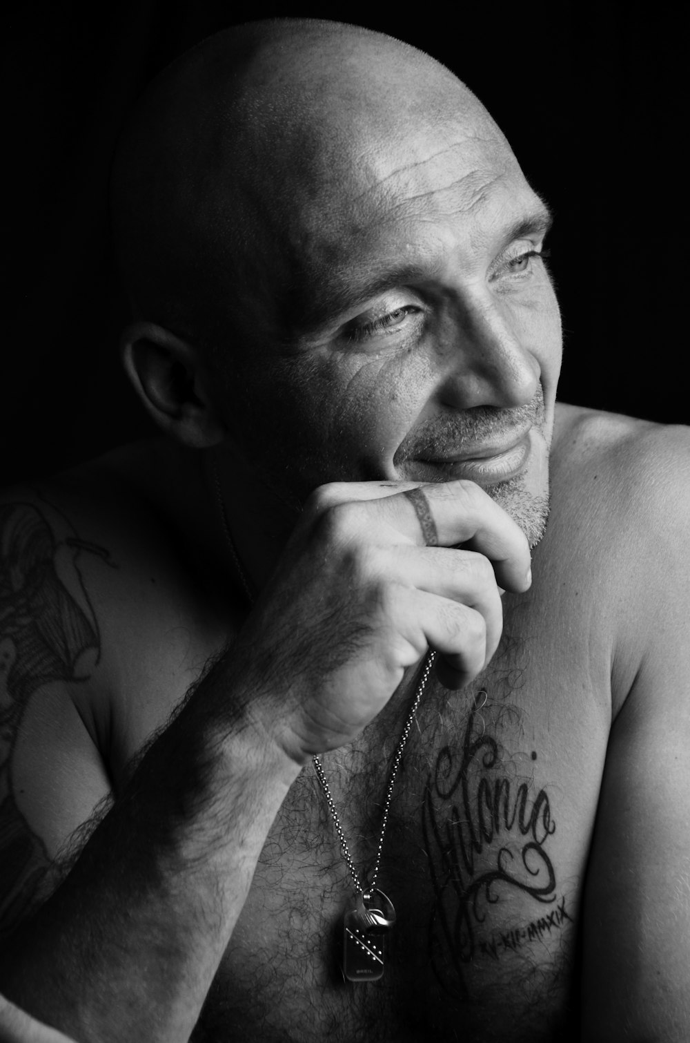 grayscale photo of man with tattoo on his right hand