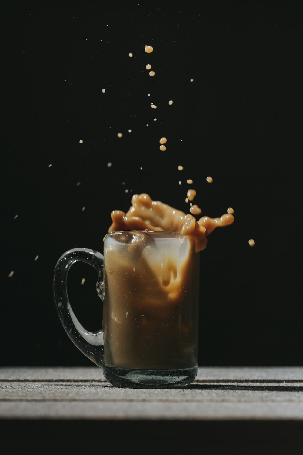 clear glass mug with coffee beans