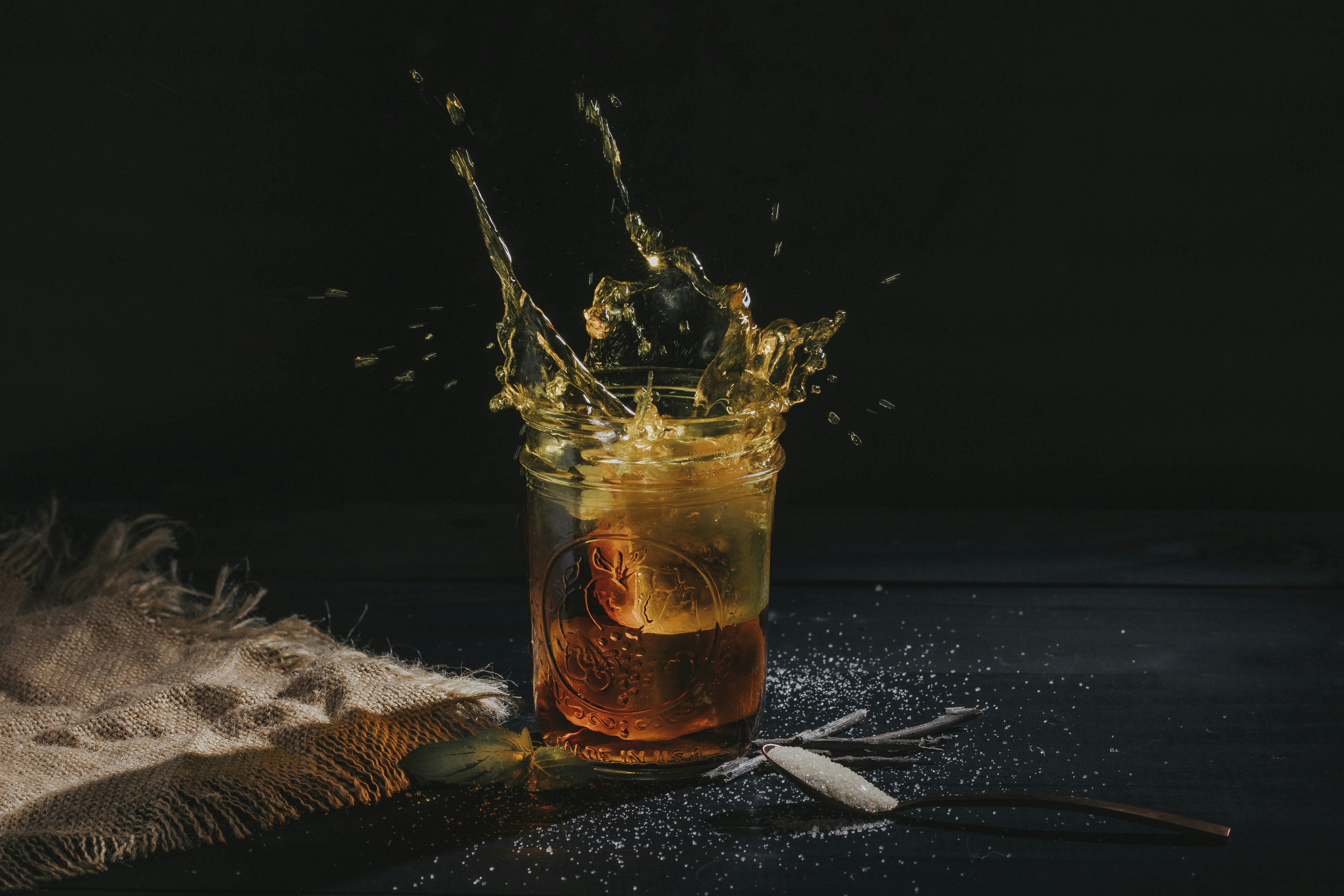 clear drinking glass with brown liquid