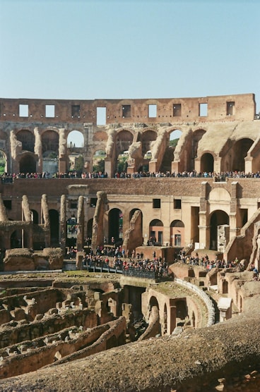 people walking on brown concrete building during daytime