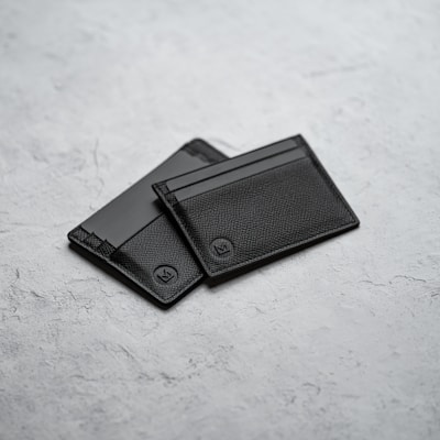 Black leather bifold wallet on white surface