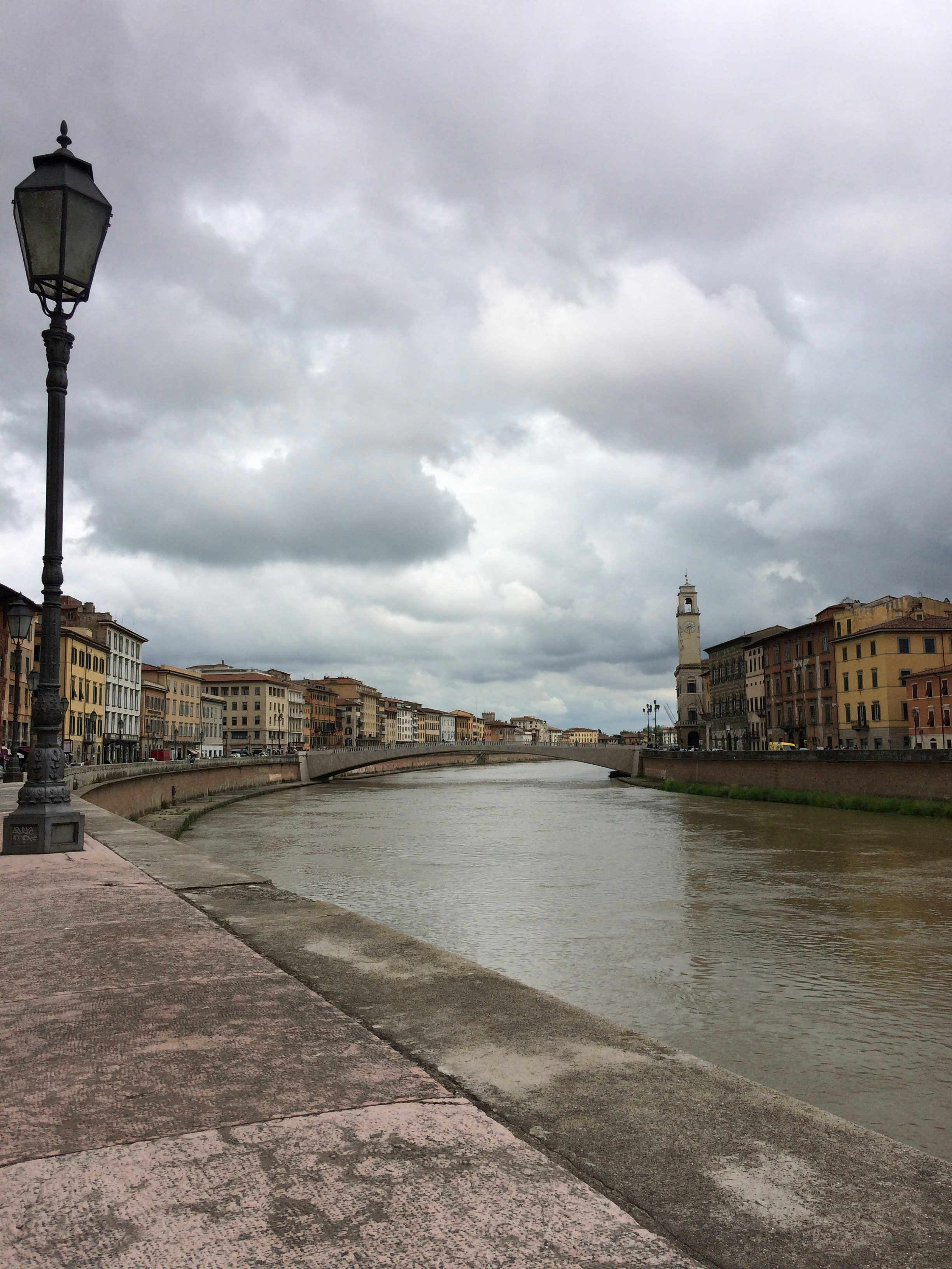 Brown concrete building near river under white clouds during daytime ...