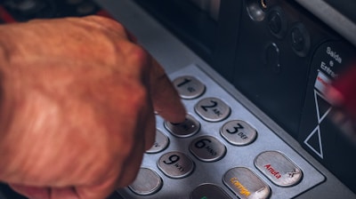 person holding gray and black control panel