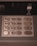 A close-up view of a numeric keypad typically found on ATMs, featuring metal buttons numbered 0 to 9, along with function keys labeled in another language. The panel includes instructions for envelope deposit.