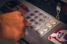 person holding white and red card
