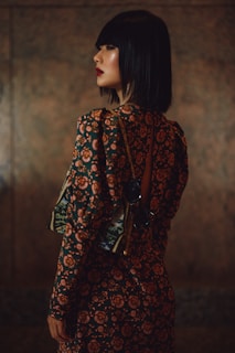 woman in red and black floral long sleeve dress